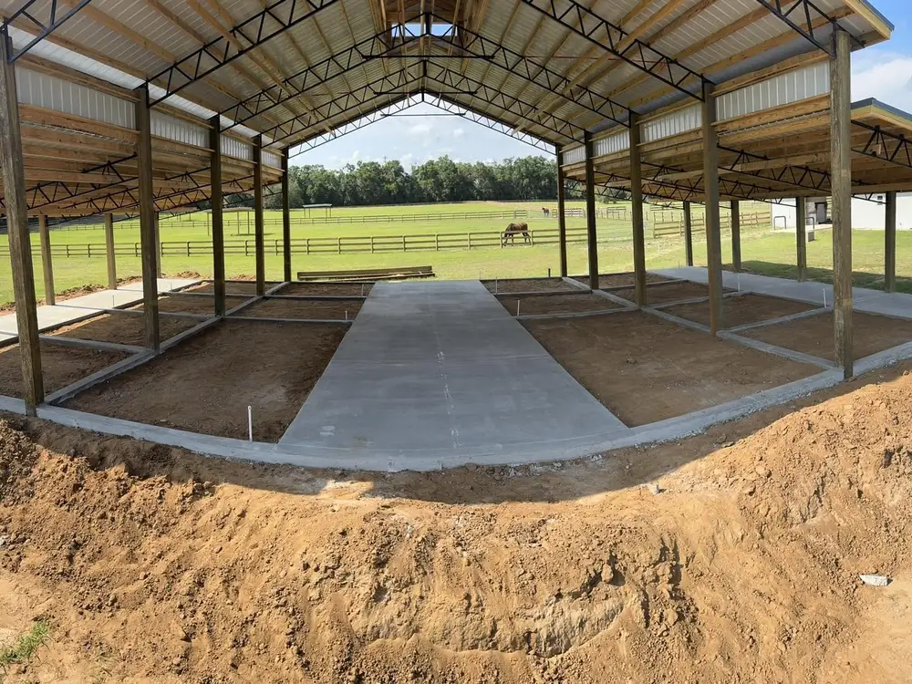 Wide concrete floor inside a finished open pavilion