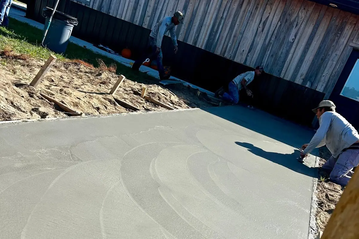 Swirl-finished concrete slab poured alongside an existing building