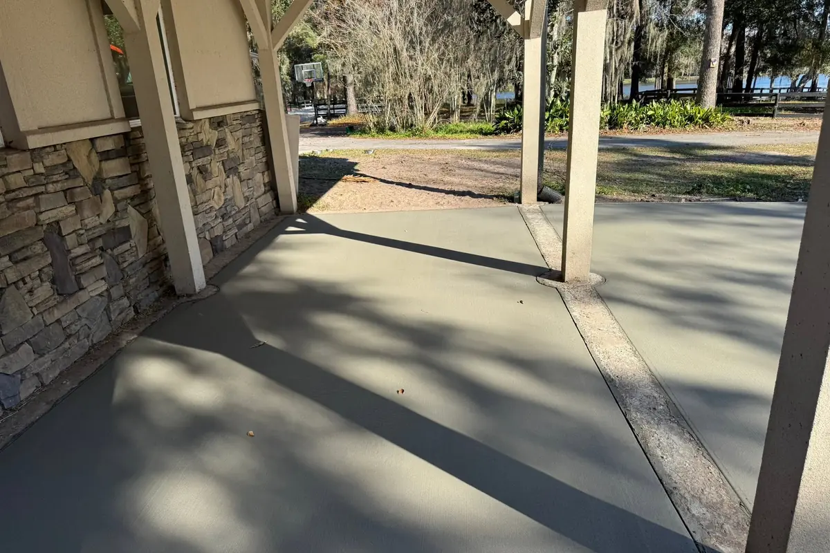 Concrete walkway and entry apron poured alongside a building